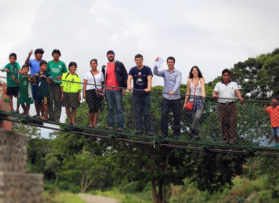 students standing on bridge