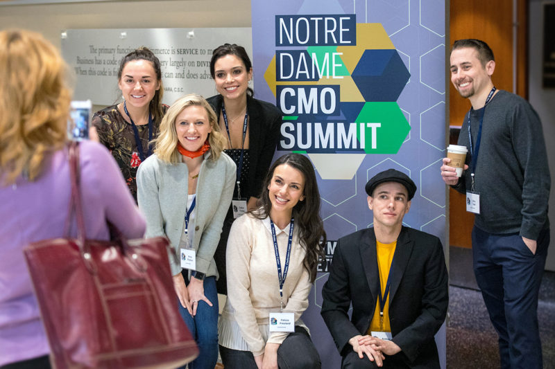 group of students in front of CMO summit sign