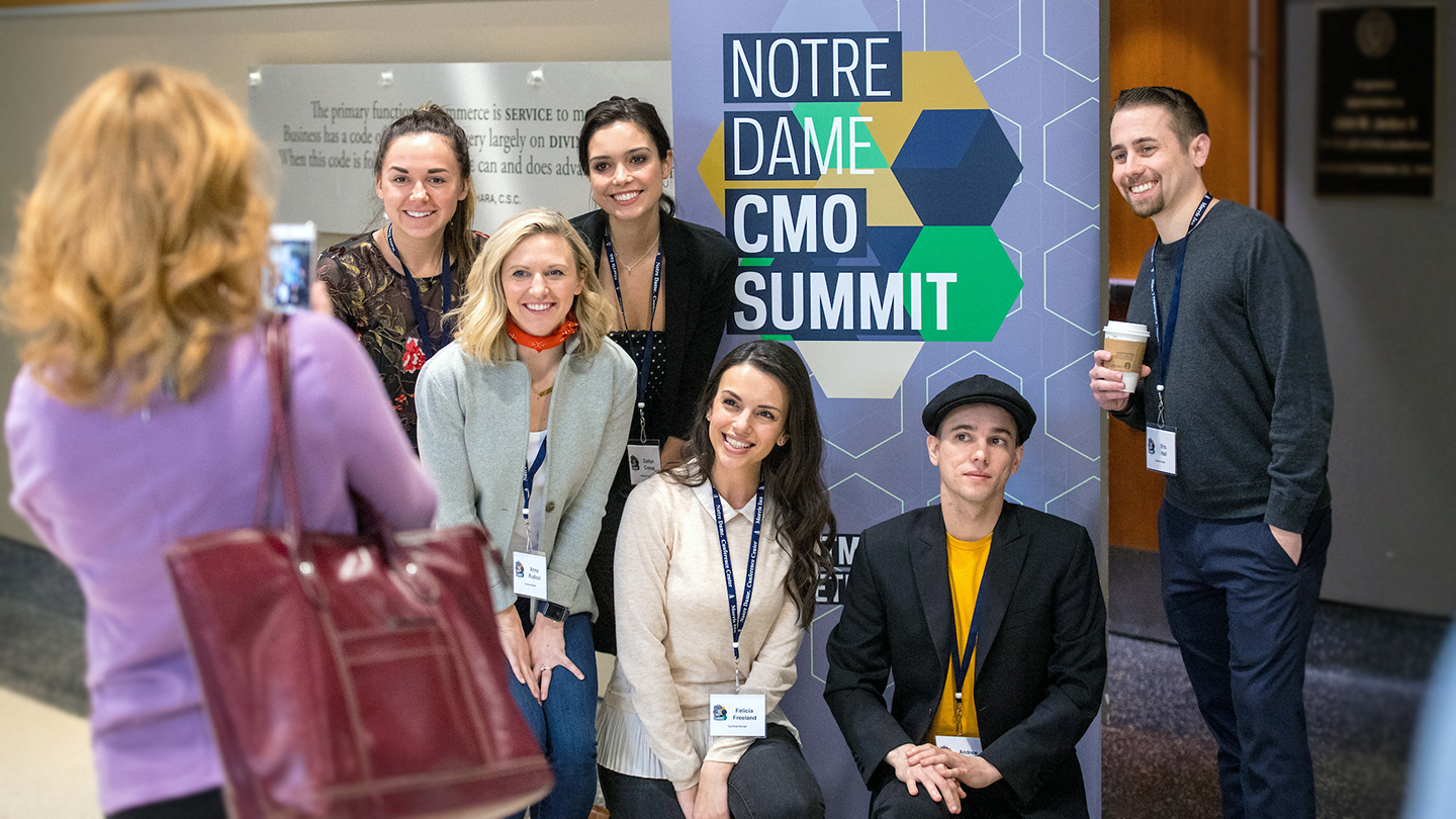 group of students in front of CMO summit sign