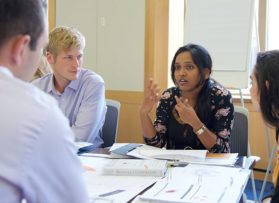 group of students talking in class
