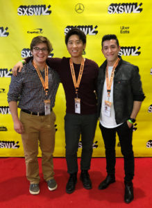three members of the Resonado team stand in front of the SXSW yellow background