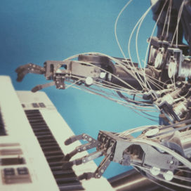robotic arms playing a piano
