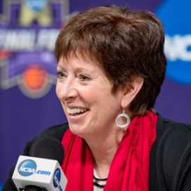 coach muffet mcgraw speaking into a microphone