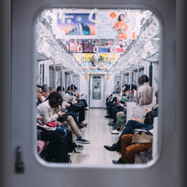 view through a window of people on a subway in Japan
