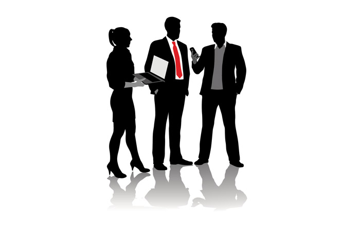 Silhouette of three business people one with a red neck tie