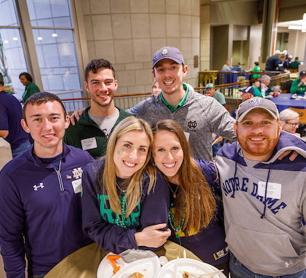group of five people wearing Notre Dame gear