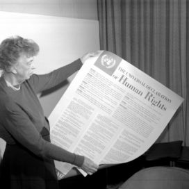 archived photo of woman reading newspaper about human rights