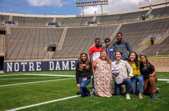 MBA students posing on the Notre Dame football field.