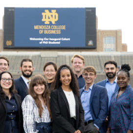 group shot of first Mendoza phd students in the Notre Dame stadium