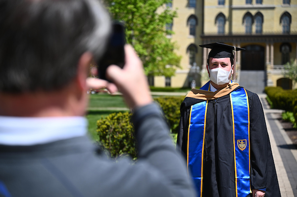 A man photographing a 2020 grad