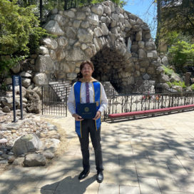 student in front of the grotto