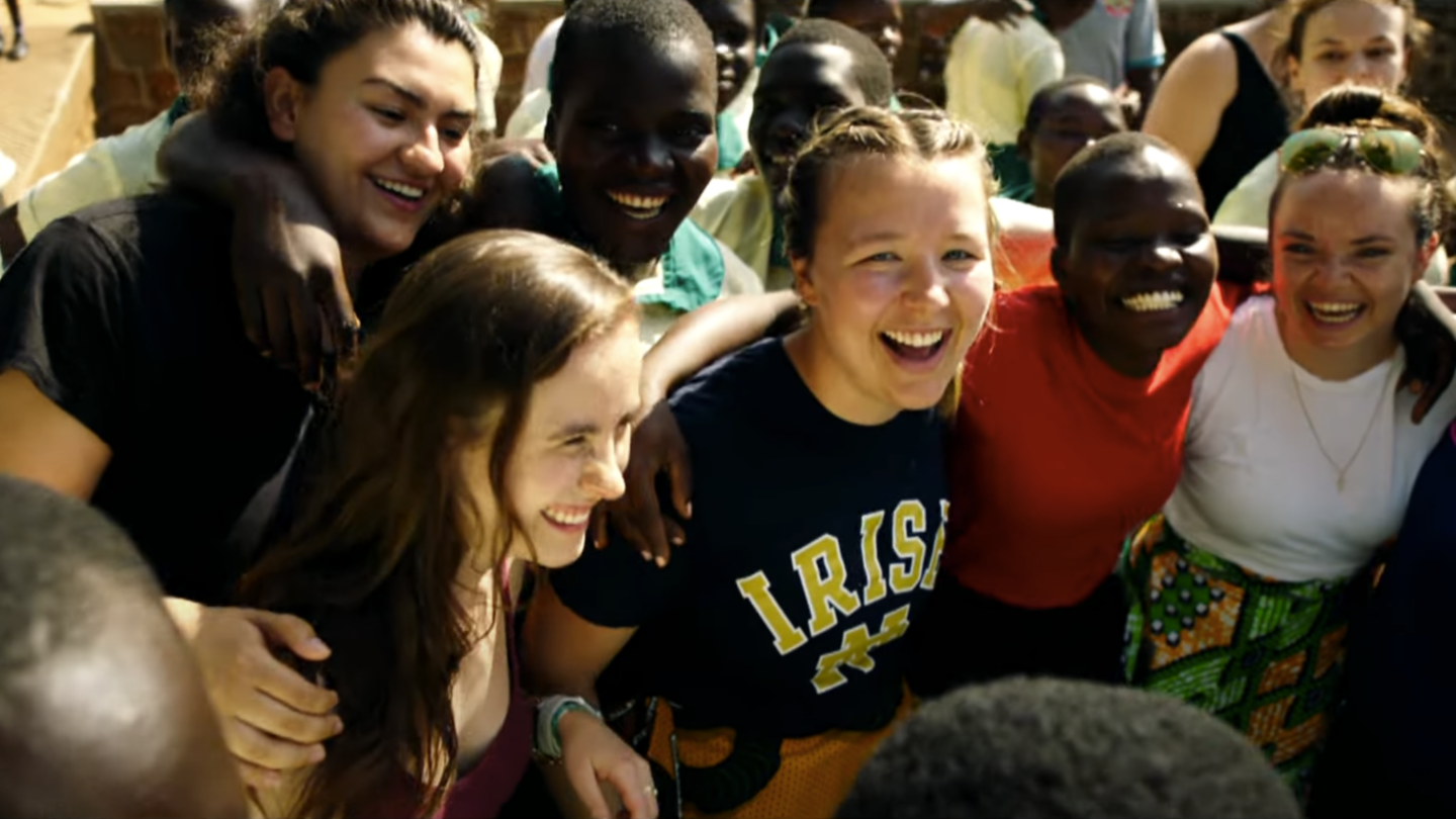 group of laughing Mendoza students with Ugandan students