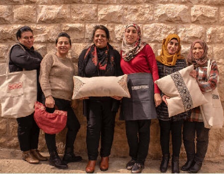 group of women holding items they have made