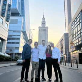 Deloitte Scholars stand on a street in Warsaw, Poland