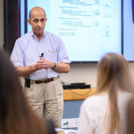 accountancy professor ken milani teaching in a classroom.