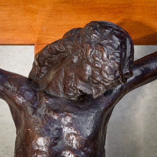 a close up view of the head and chest of Christ as depicted on the bronze casting.