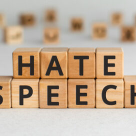 wood letter blocks that spell out "hate speech"