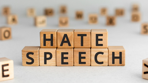 wood letter blocks that spell out "hate speech"