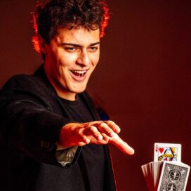 Jacob Baum reaches out for a card in a deck that he can't see.