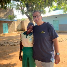 Jake Williams stands with a scholar from Saint Bakhita Vocational Training Center