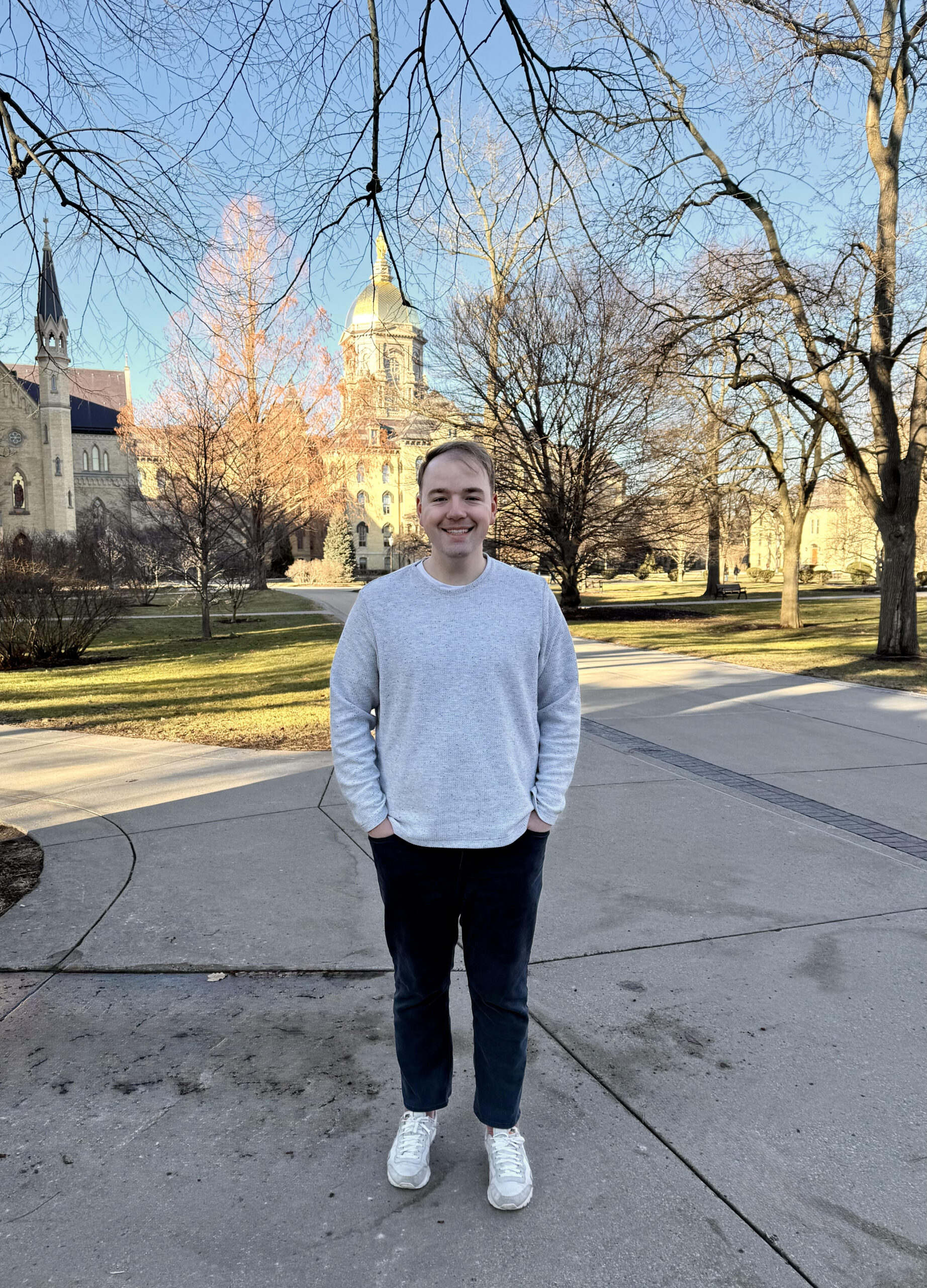 MNA student Mason Mishler stands in front of the Notre Dame Main Building