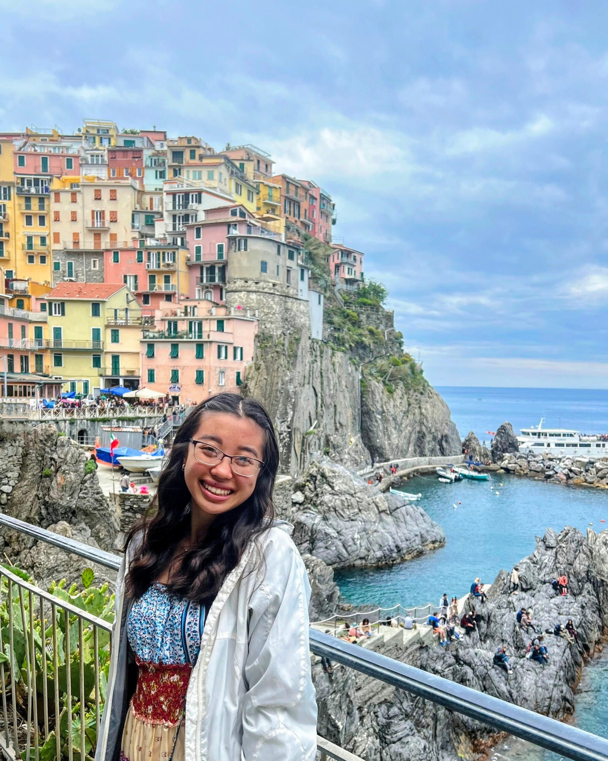 Katherine Huang poses for a picture with the Italian countryside behind her. 