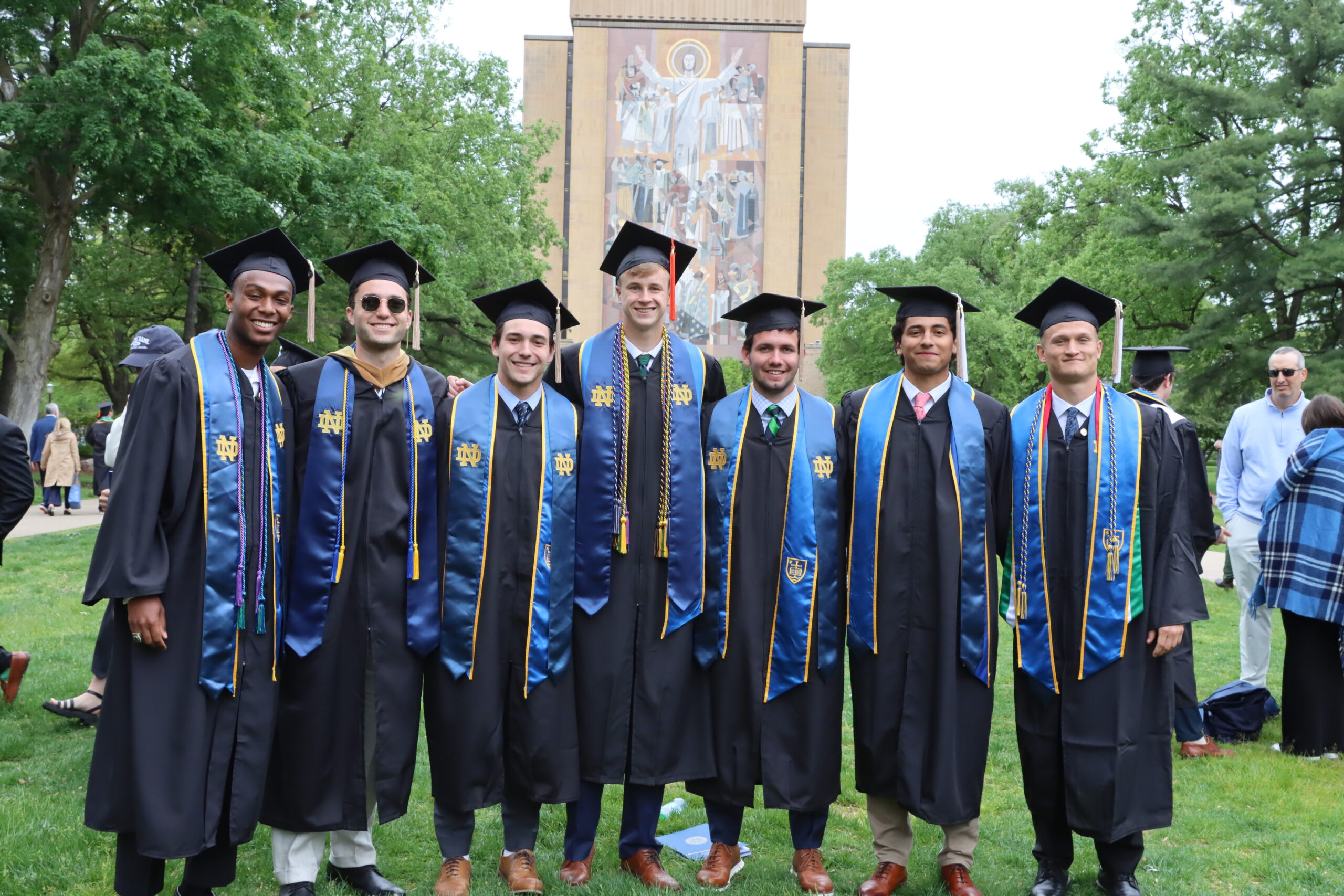 Cleveland Sellers IV stands with friends in their caps and gowns on graduation day.